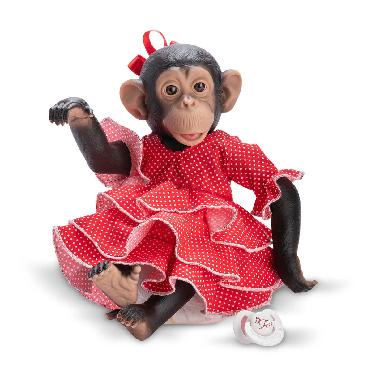 Chimpanzee doll in a red polka dot flamenco dress with a pacifier beside her, sitting playfully.