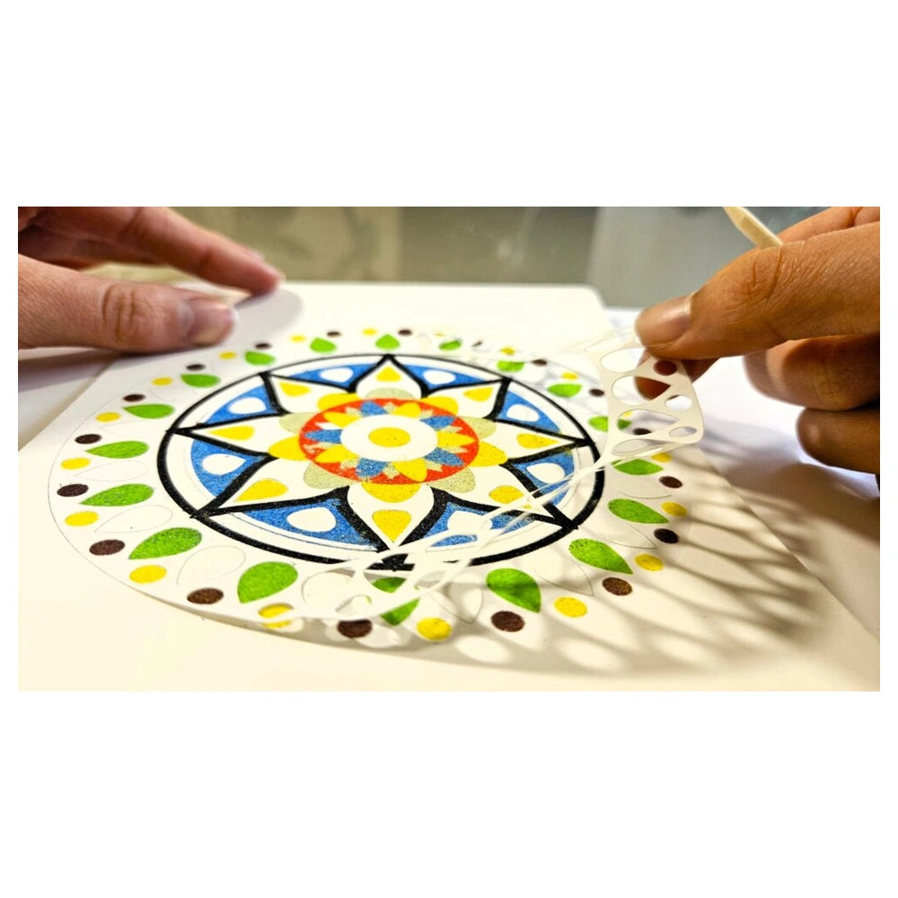 Alexander Sand Art Mandala craft project features hands cutting colorful geometric paper with scissors.