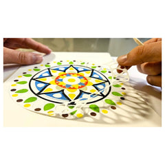 Alexander Sand Art Mandala craft project features hands cutting colorful geometric paper with scissors.