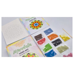 Alexander Sand Art Mandala kit features an open book, colorful sand packets, and a mandala template on a tabletop.