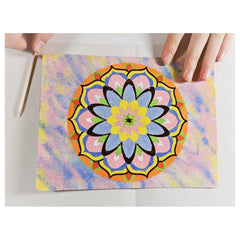 Sand Art Mandala showcases a colorful, intricate design held by a hand against a light background, highlighting its vibrant d
