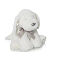 White plush dog with gray bow and polka-dotted paws, sitting upright.