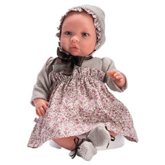46 cm ASI Dolls Leo in a floral dress with a matching bonnet, featuring a soft, serene expression.