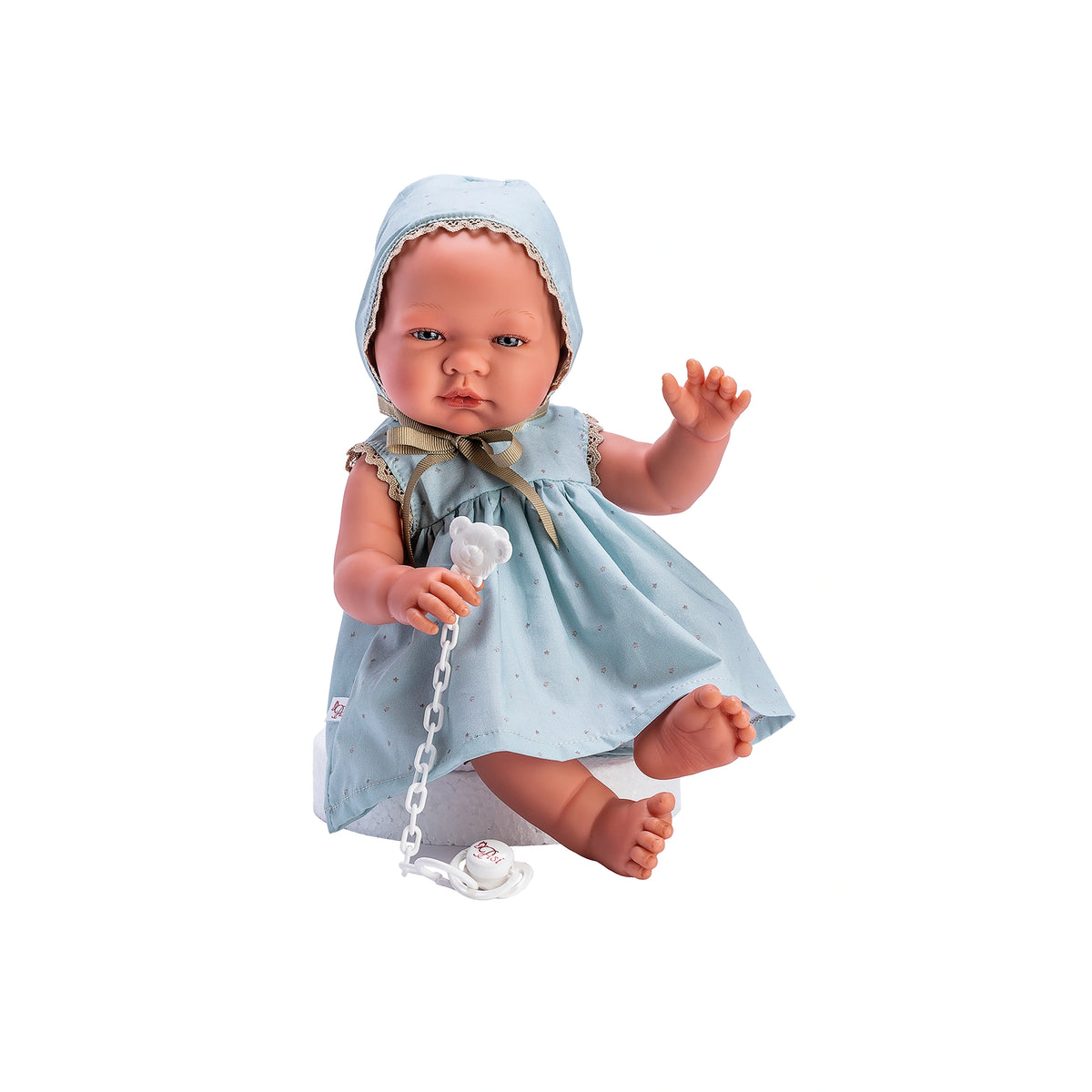 ASI Dolls María in a blue star dress with matching bonnet, holding a white pacifier chain.
