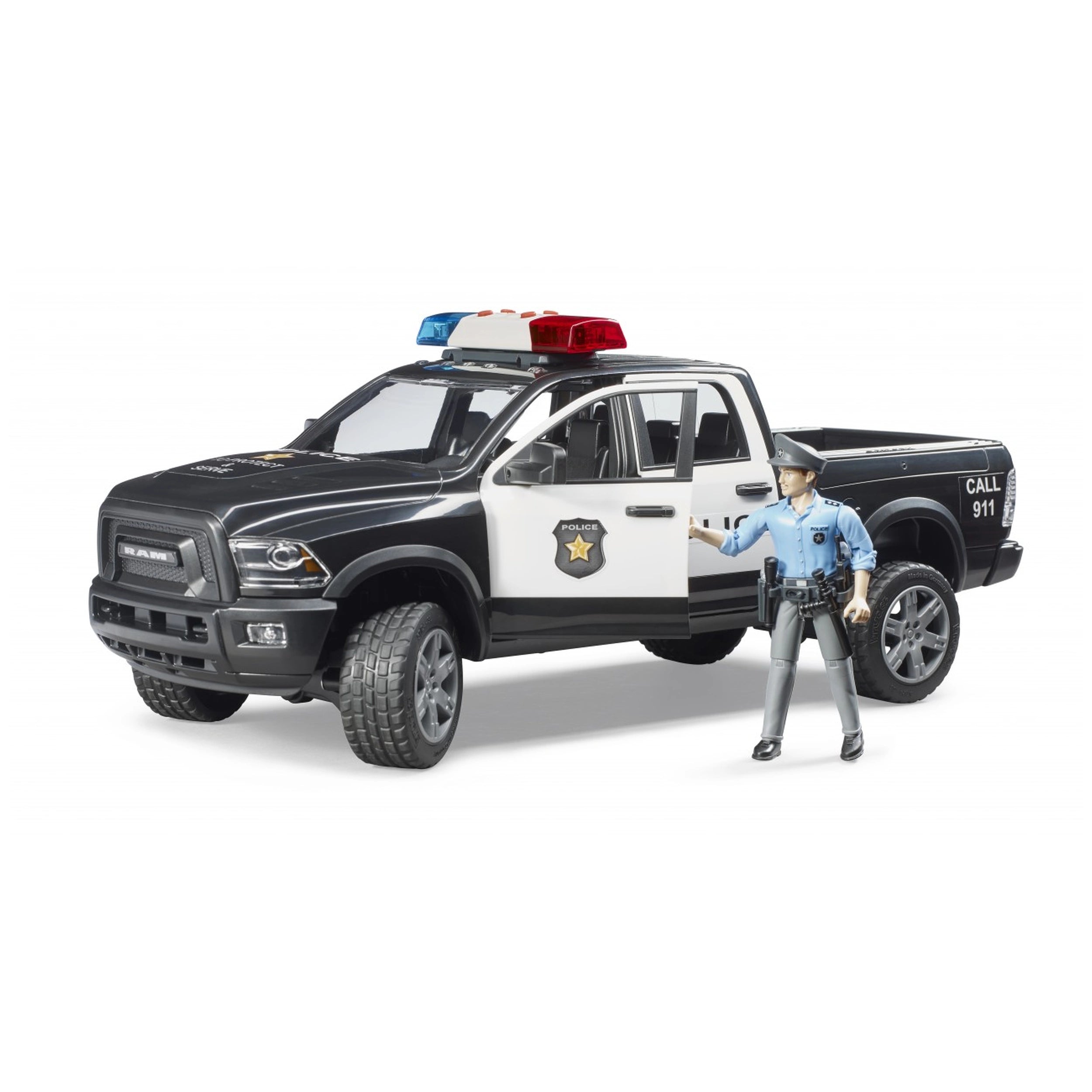 Black and white Bruder RAM 2500 police truck with red and blue lights, includes police officer figure.