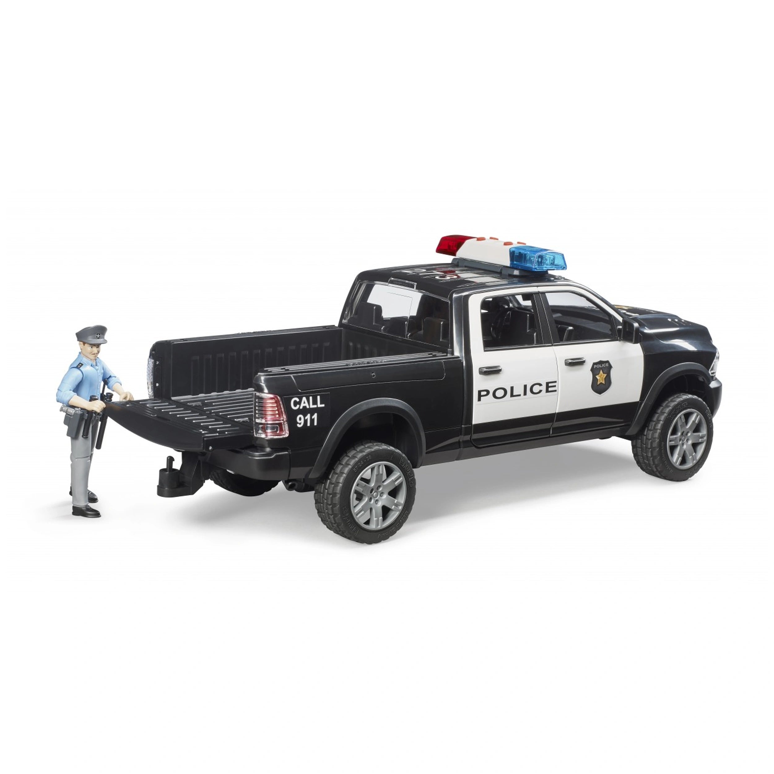 Bruder RAM 2500 black and white police truck toy with officer figurine by the tailgate.