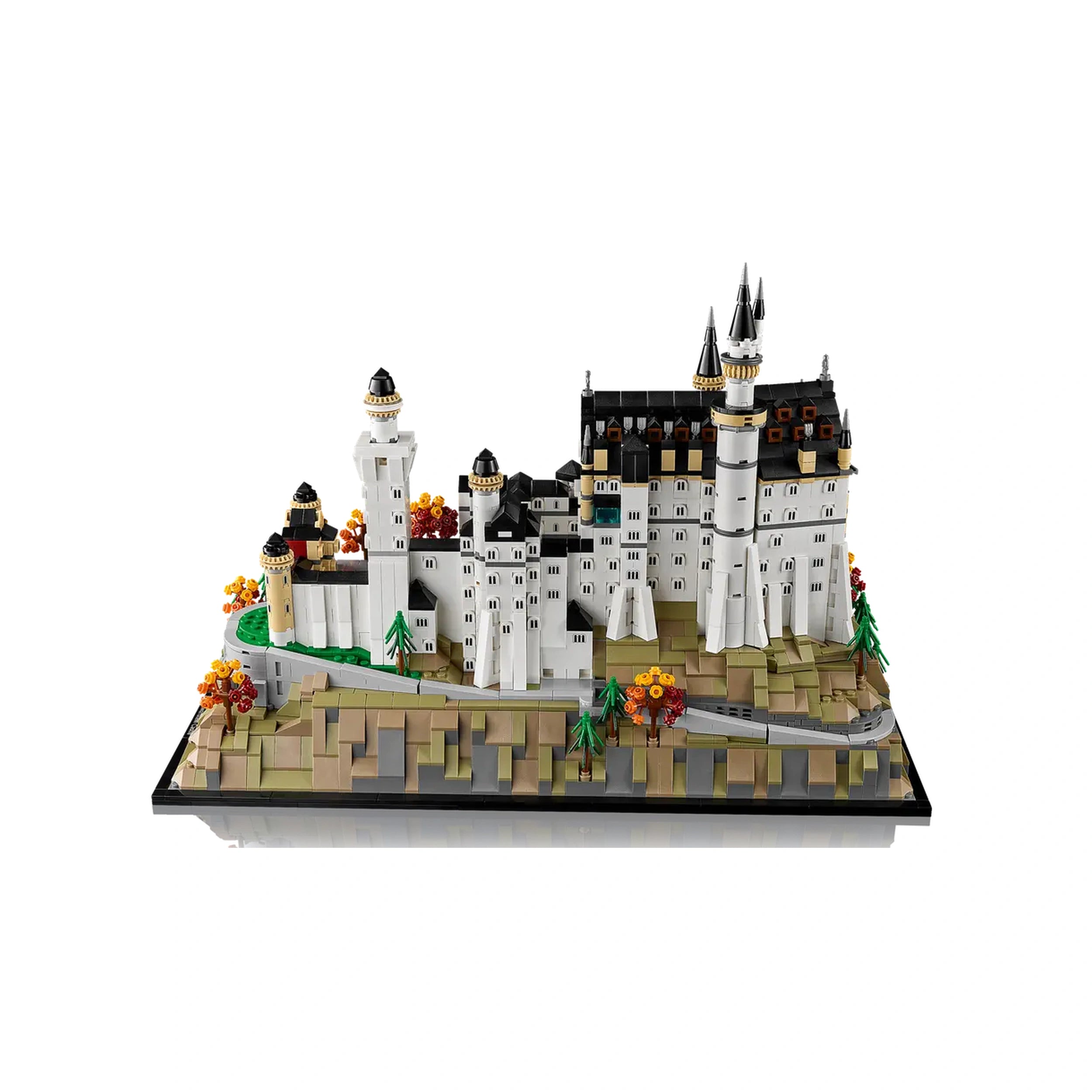 LEGO Architecture Neuschwanstein Castle set displays a detailed replica of the iconic castle with white towers, black roofs, and surrounding greenery in fall colors.