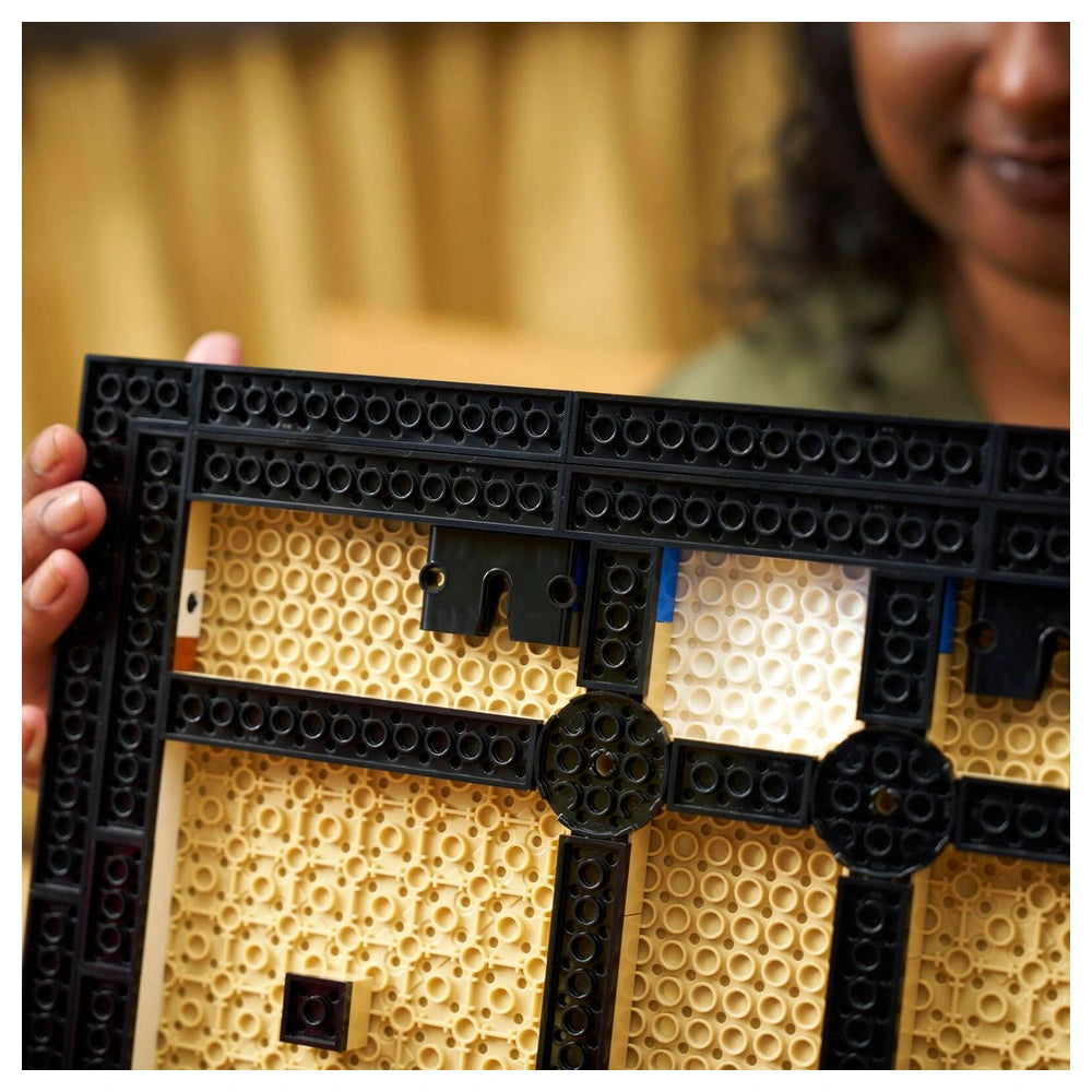 LEGO - Art - Japanese Cherry Blossom Landscape set held in a hand, featuring interlocking black and yellow plastic pieces.