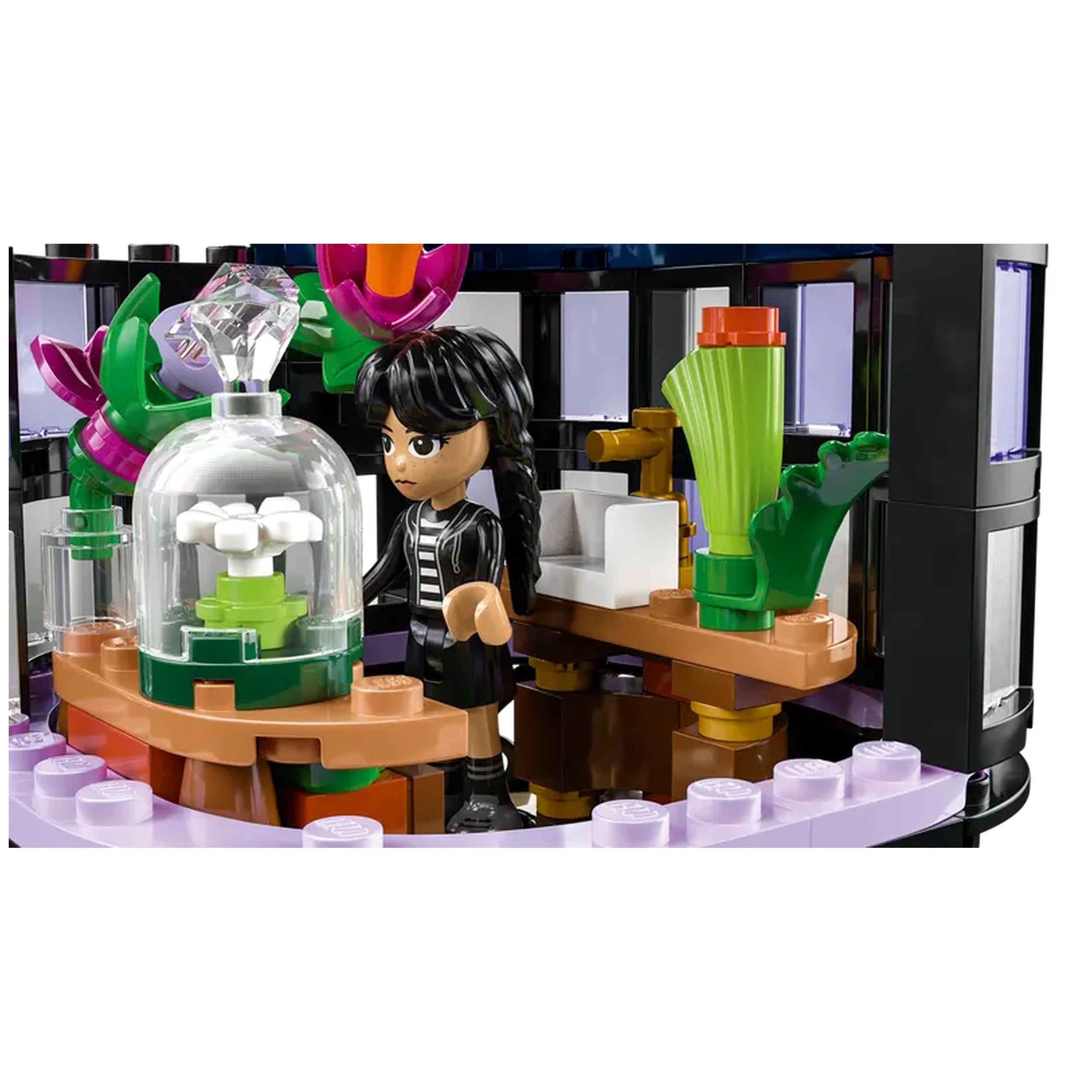 A child with black braided hair stands beside a circular table featuring a glass dome with a white flower and green base, surrounded by colorful plant elements. The background shows a stylish interior with windows, accentuating a whimsical atmosphere.