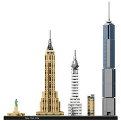 LEGO Architecture New York City set showcasing detailed models of iconic skyscrapers: Empire State Building, Chrysler Building, One World Trade Center, and Statue of Liberty, all on a black base with a decorative nameplate.