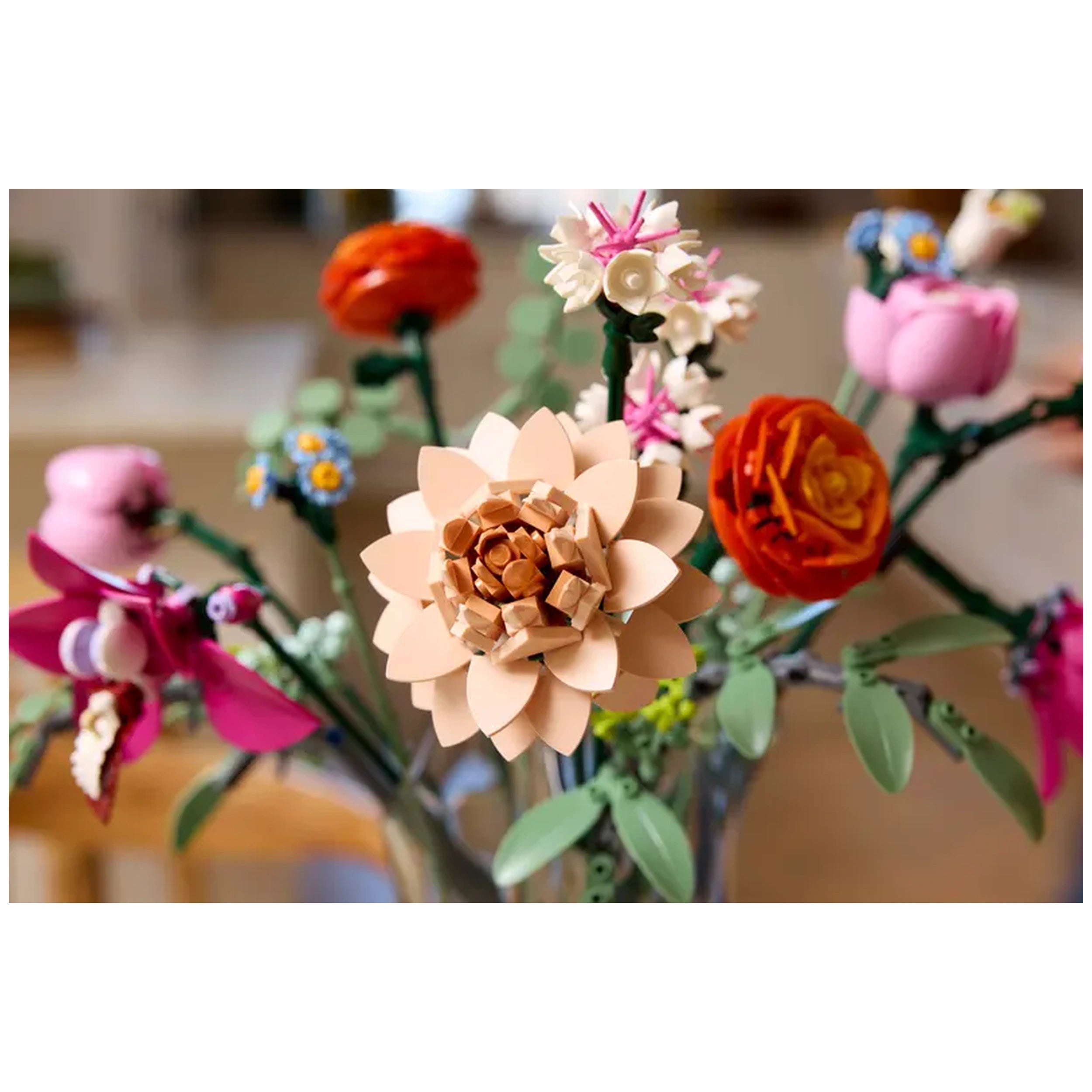 Close-up of a vibrant LEGO® Botanicals Pretty Pink Flower Bouquet showcasing a large beige flower, pink daisies, and colorful blossoms.