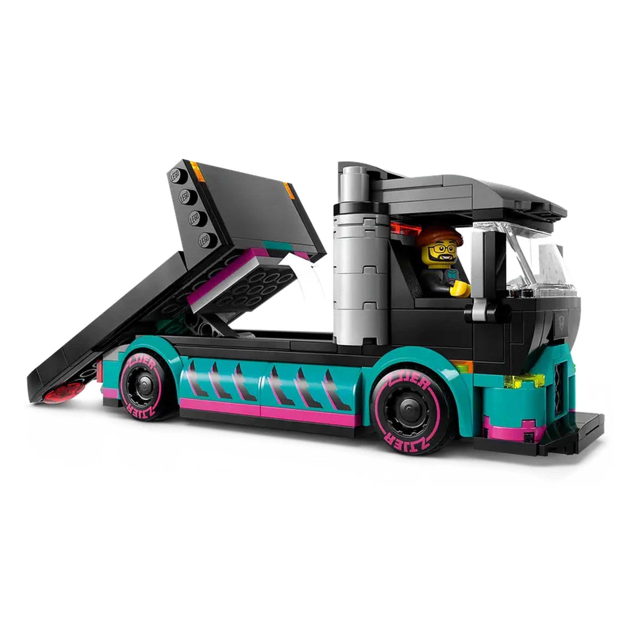 Colorful LEGO City car carrier truck with a raised loading ramp, featuring a smiling minifigure driver in glasses.