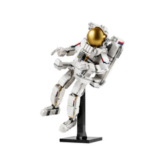 A highly detailed LEGO astronaut figure in a white suit with a gold visor, posed on a black stand, ready for space adventures.