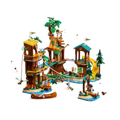 LEGO® Friends Adventure Camp Tree House set featuring colorful tree houses, mini-dolls, and a zip line, surrounded by pine trees and water.