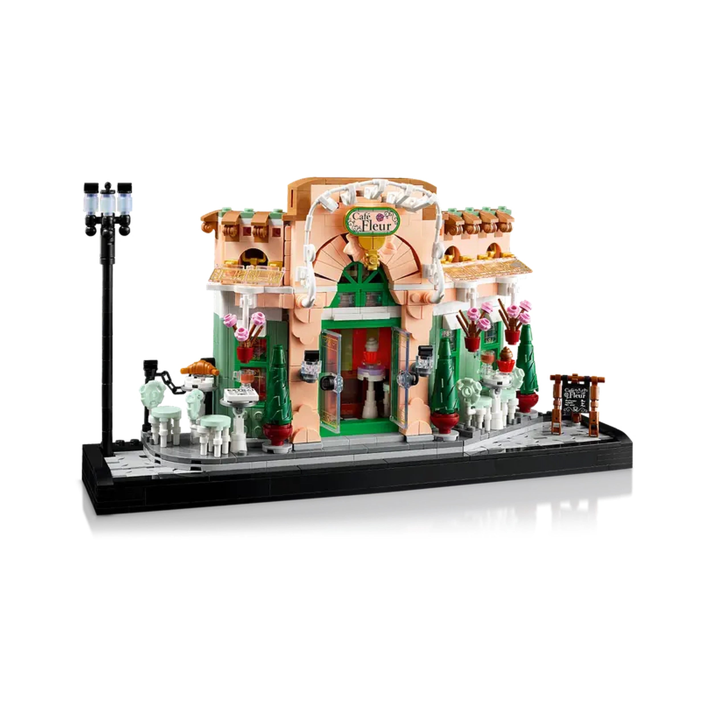 LEGO Icons French Café construction set showcasing a charming bistro facade with flower pots, outdoor seating, and a classic streetlight.