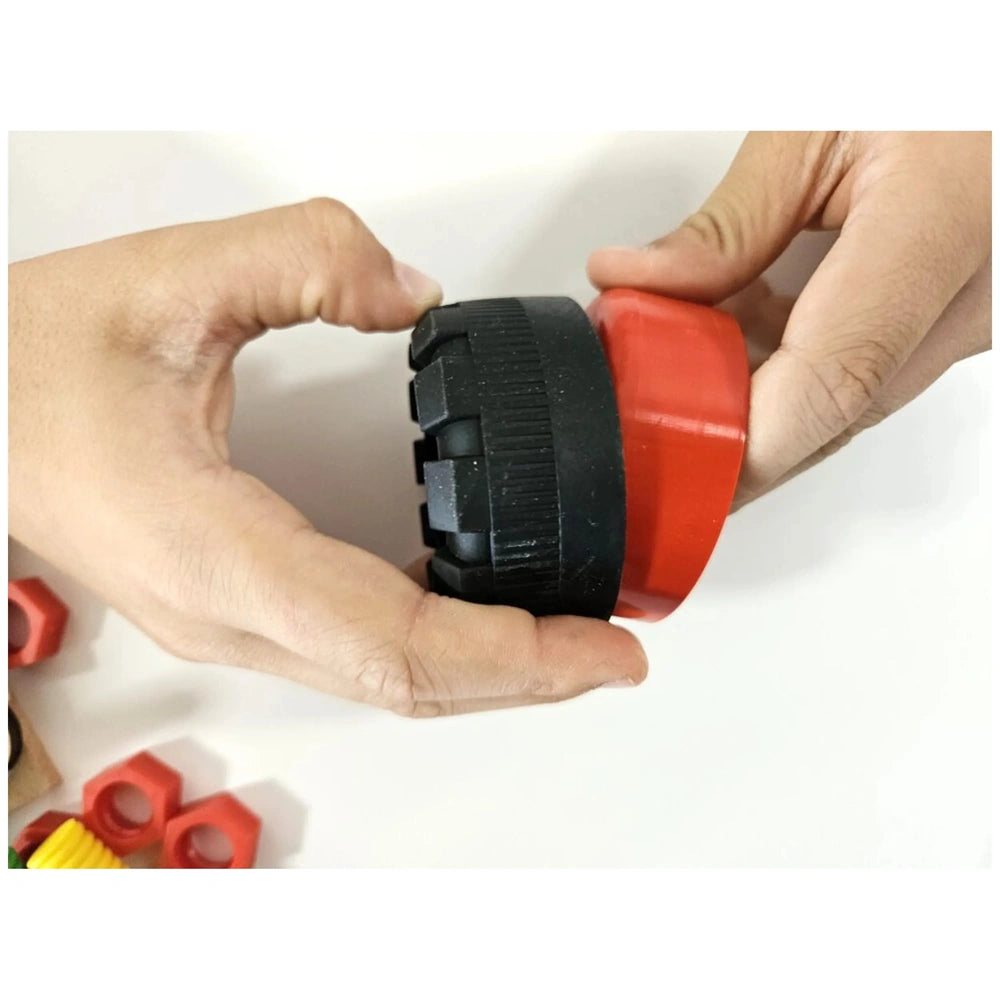 Hands holding a black and red wheel piece from the Alexander Maly Constructor Junior buggy set.