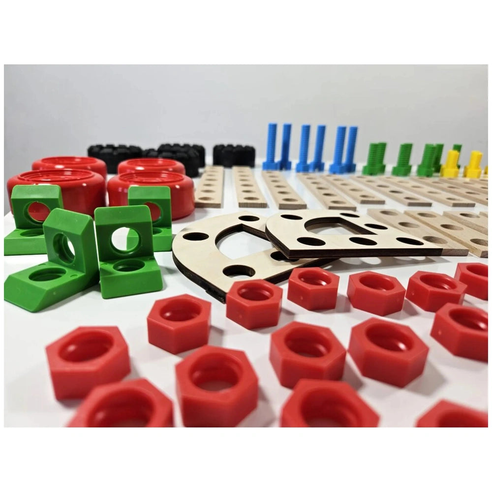 Colorful construction set components including red wheels, green and yellow connectors, blue pegs, and wood pieces.