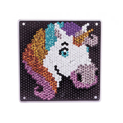 A unicorn design made of colorful beads on a pierced synthetic material against a black background.