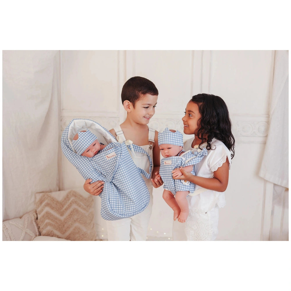 ASI Dolls baby carrier for dolls displayed with a family in a soft, pastel indoor environment, highlighting playtime joy.