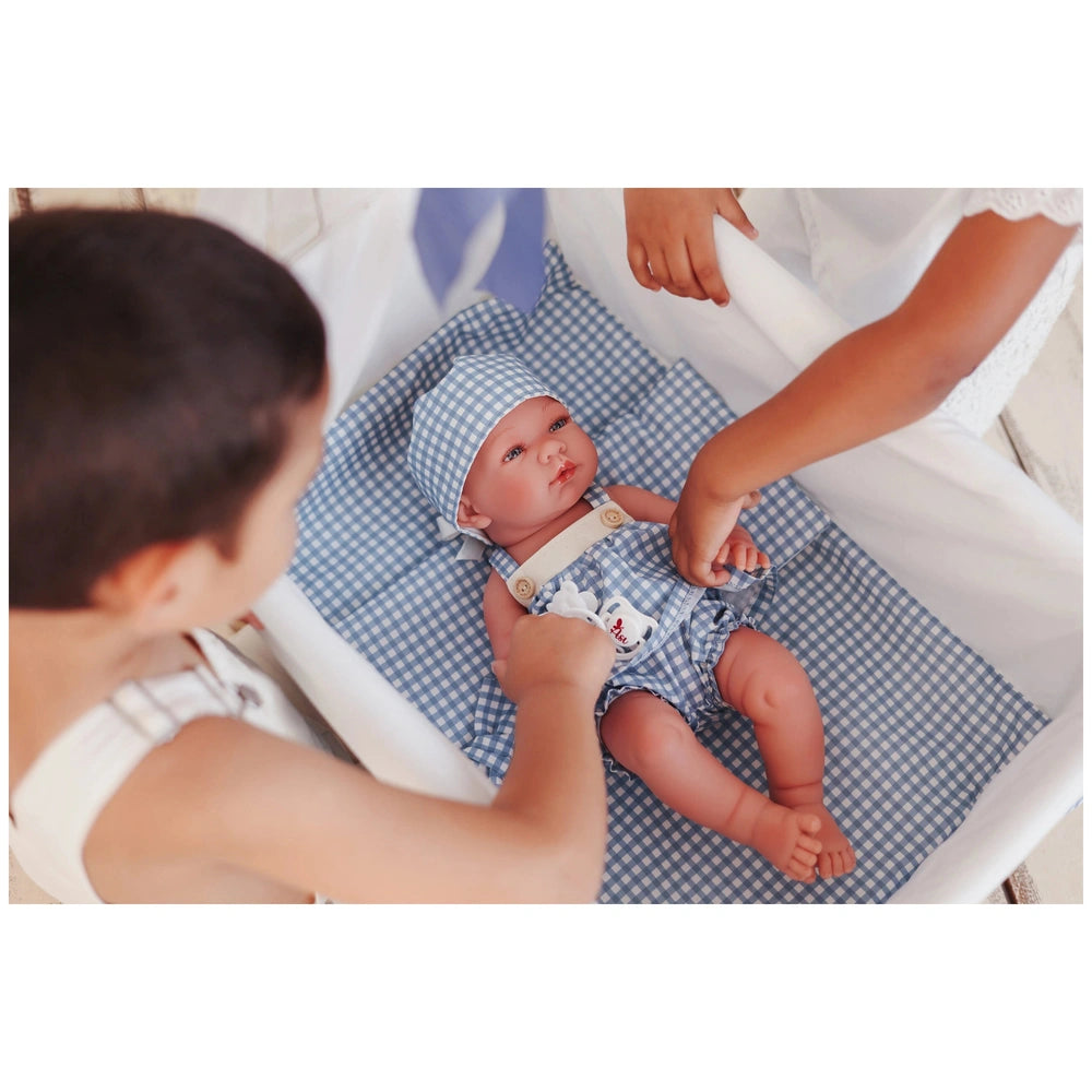 ASI Dolls - Pablo and Maria Vinyl Dolls in a serene indoor setting, a light-skinned baby in a bassinet with a helper.