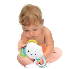 Baby Clementoni Rainy Cloud Rattle in a child's hands, featuring a colorful smiling cloud design.