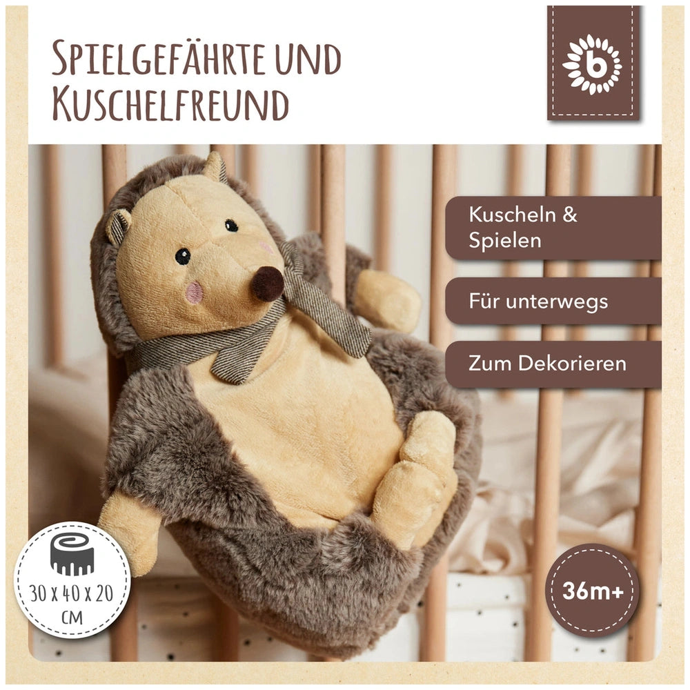 Piksi the Hedgehog, a soft stuffed animal with a chocolate and oatmeal color scheme, rests against wooden crib bars, exuding warmth and charm.