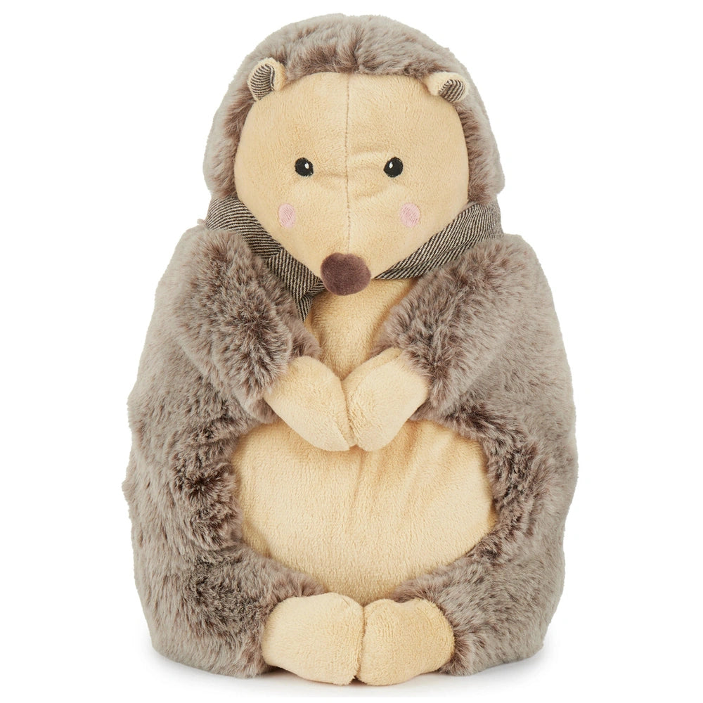 Piksi the Hedgehog, a soft stuffed animal with a cream belly and gray, fuzzy exterior, holds its paws together. It features a cute face with black eyes and a small brown nose, topped with a simple striped collar, inviting cuddles and imaginative play.