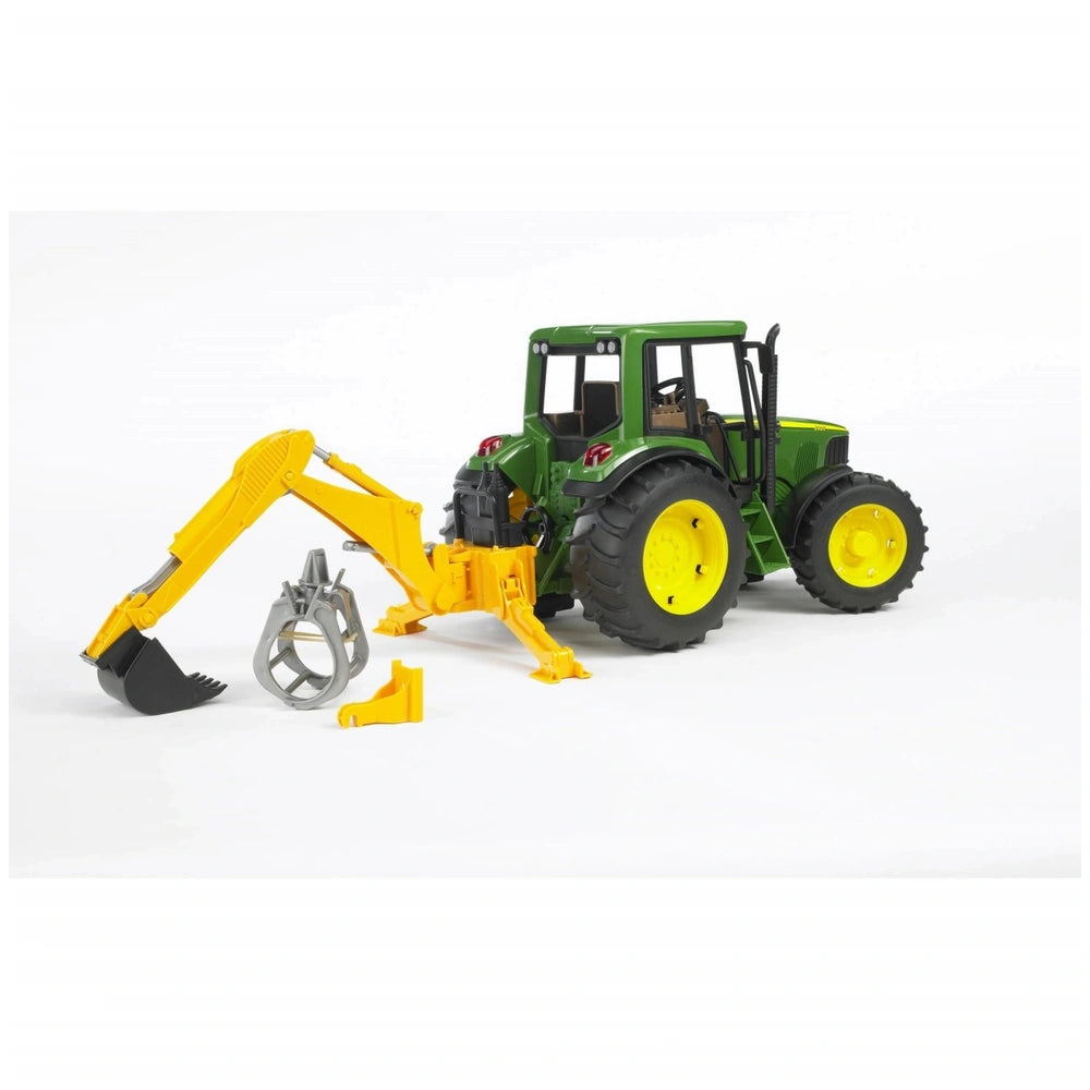 Green toy tractor with yellow wheels and a rear hydraulic arm, featuring a detachable digger and grabber, on a white background.