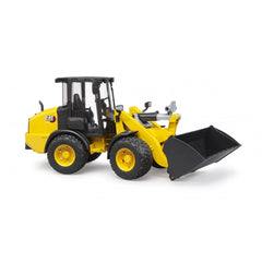 Yellow Bruder Cat Wheel Loader toy with black tires and a movable front shovel.