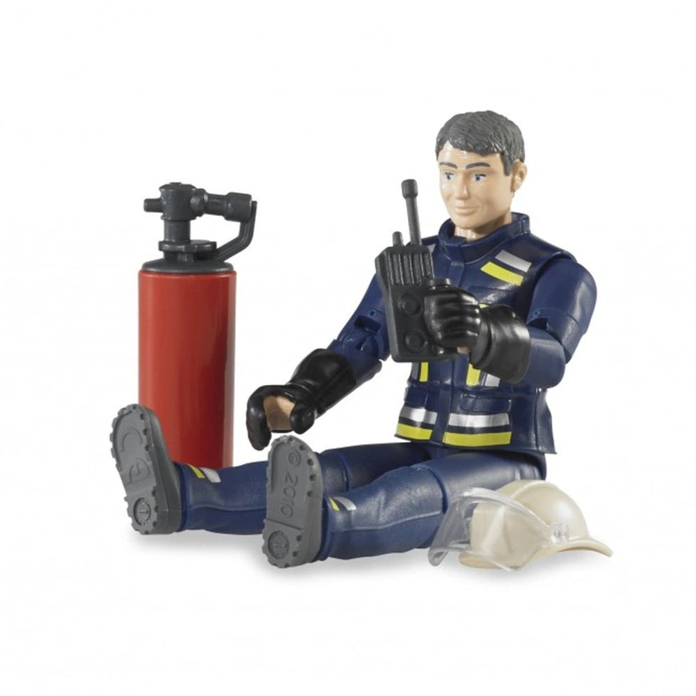 Toy firefighter figure in blue uniform holding a walkie-talkie, with a red fire extinguisher and white helmet nearby.
