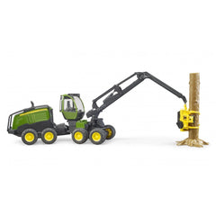 Bruder John Deere 1270G Harvester toy with rotating cabin, eight wheels, and a gripping arm holding a tree trunk.