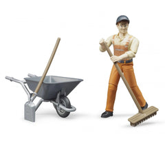 Municipal worker figure in orange attire with broom, next to toy wheelbarrow and shovel, for imaginative play.