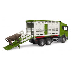Green and white toy cattle transport truck with brown cow on ramp.