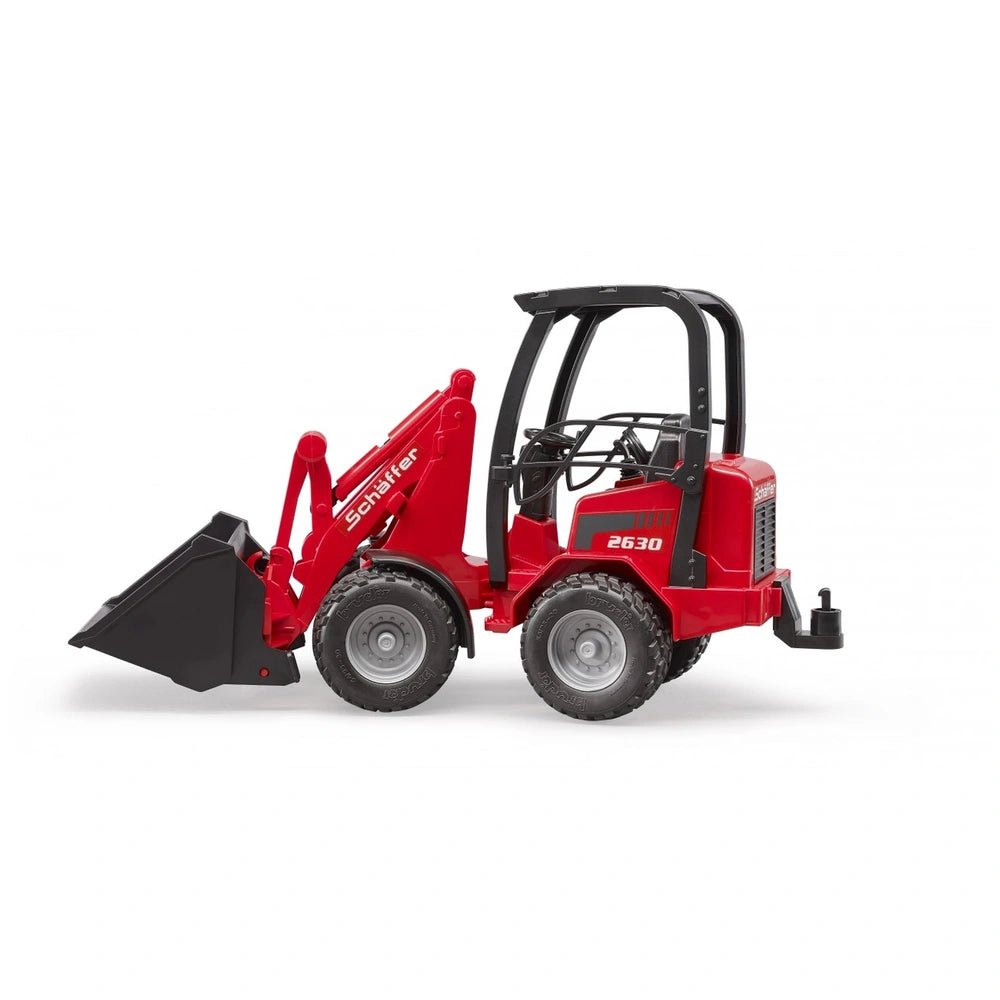 Red Bruder Schäffer Compact Loader 2630 with functioning bucket and kink steering, shown in side view.