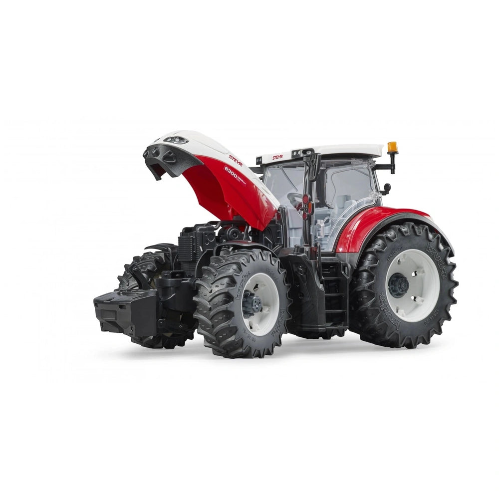 Red and white Bruder Steyr 6300 Terrus CVT toy tractor with open hood, large tires, and detailed cabin.