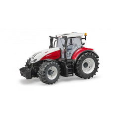 Red and white Bruder Steyr 6300 Terrus CVT toy tractor with large black tires and detailed cabin.