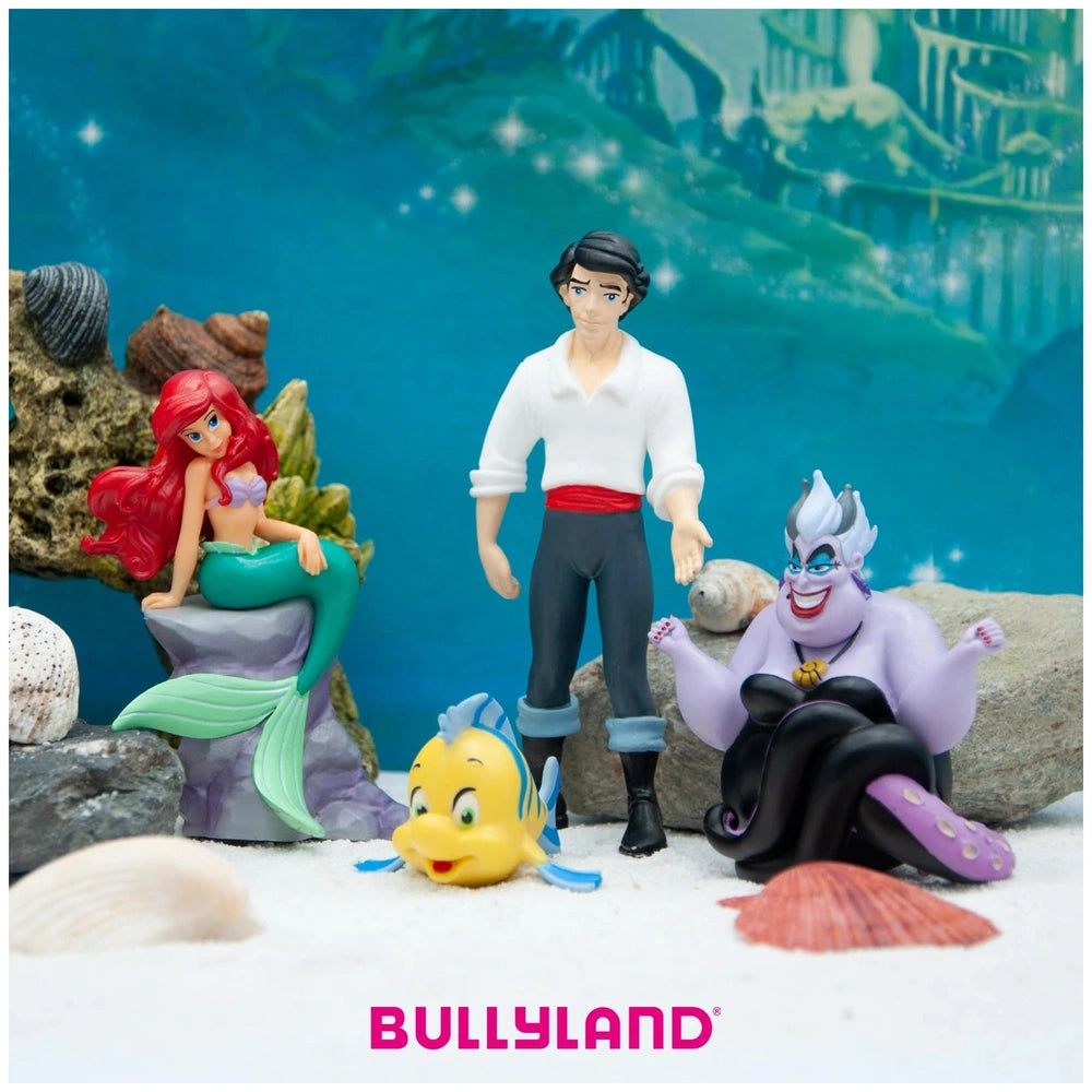 Ariel toy figure from Bullyland, surrounded by colorful plastic rocks and shells against a blue ocean background.