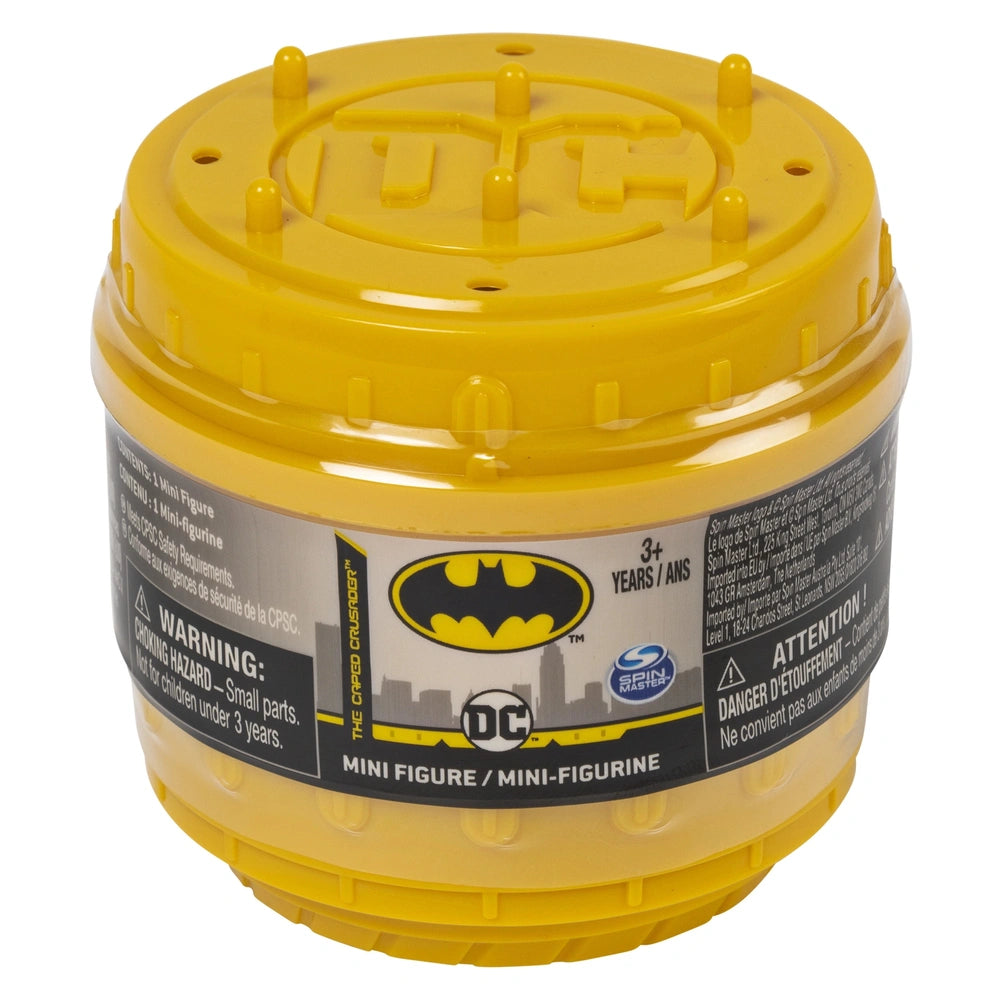 DC Comics BATMAN collectible blind box mini figure container with a yellow lid, black base, and ventilation holes.