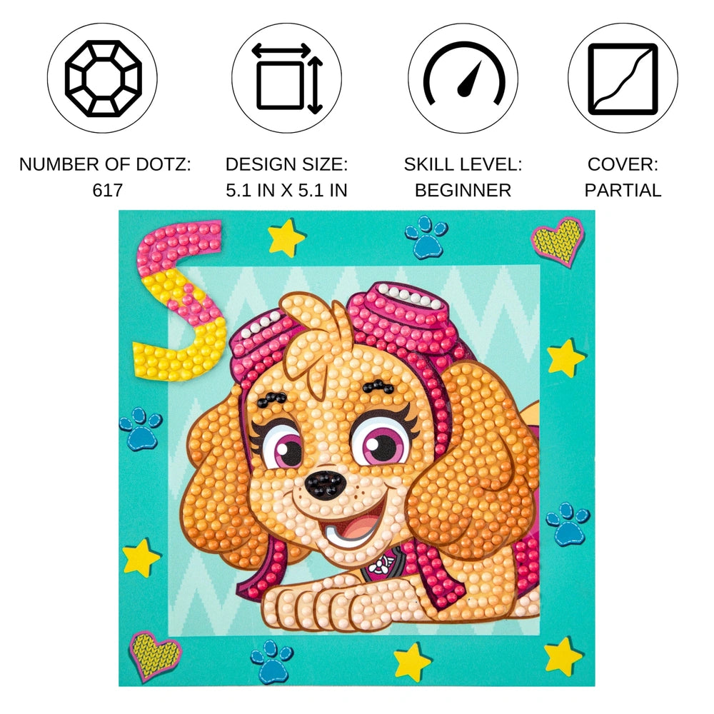 Diamond Dotz Dotzies Paw Patrol Skye features a brown dog with pink accents on a glossy blue background, showcasing stars and