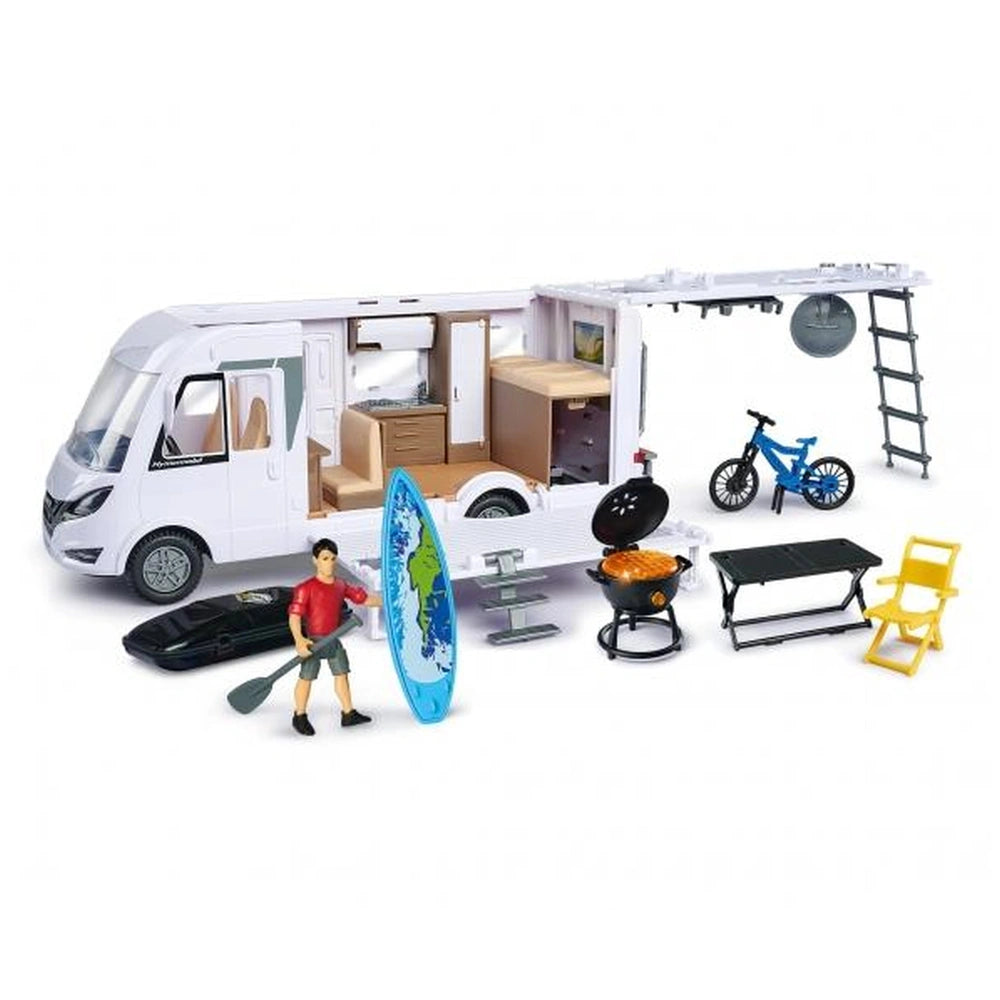 Dickie Hymer camper pop-up set features a white camper shell, black wheels, and various colorful accessories like chairs and 