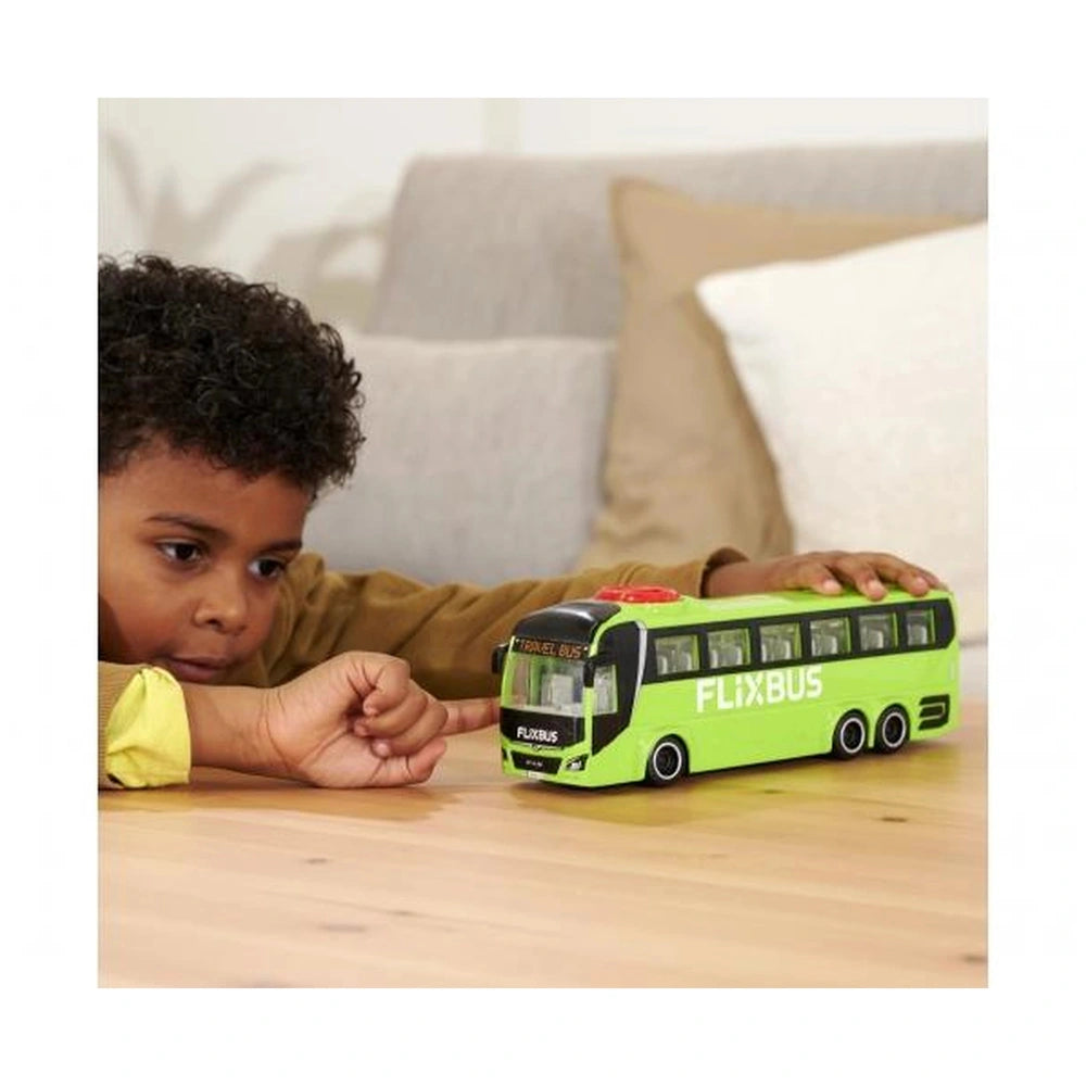 Dickie - Man Lions Coach toy bus in green with black details, red roof, and child in a brown jacket playing on wooden surface