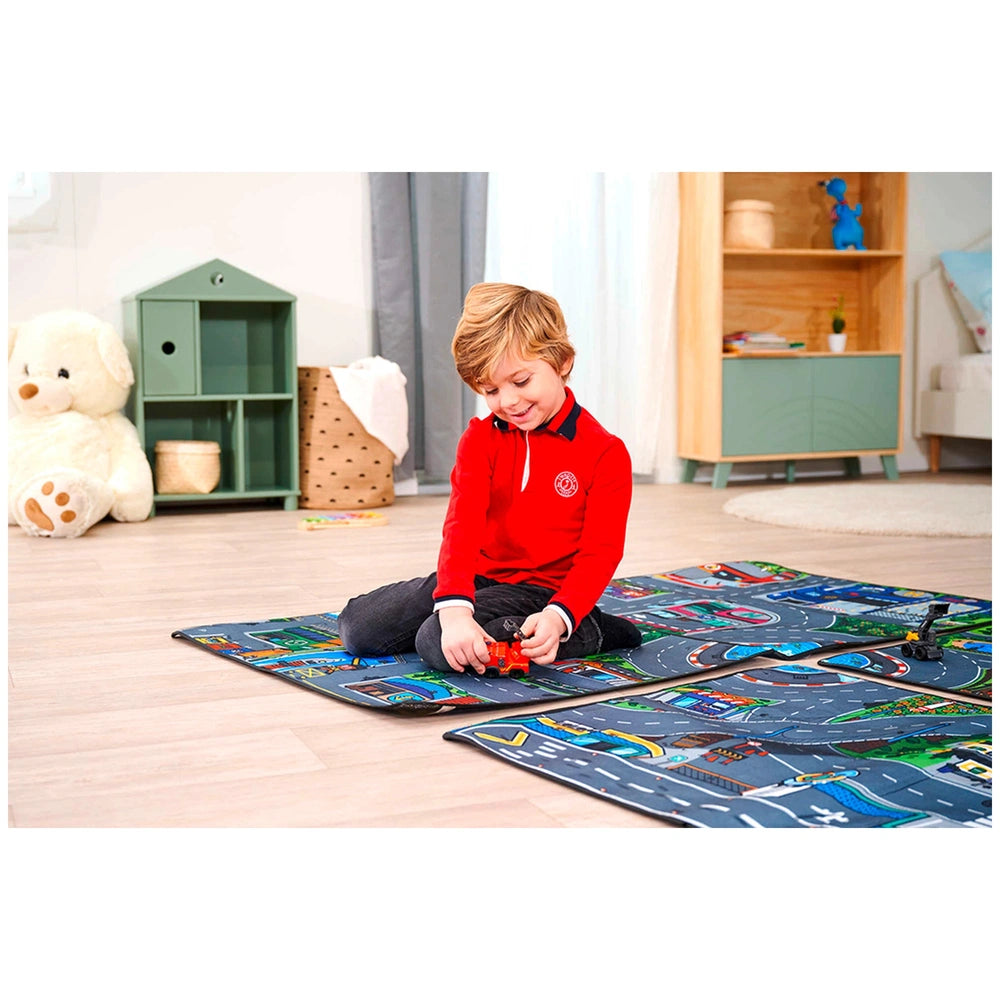 Dickie Playmat featuring a child playing with colorful plastic toy cars on a vibrant multi-colored track on a wooden floor.