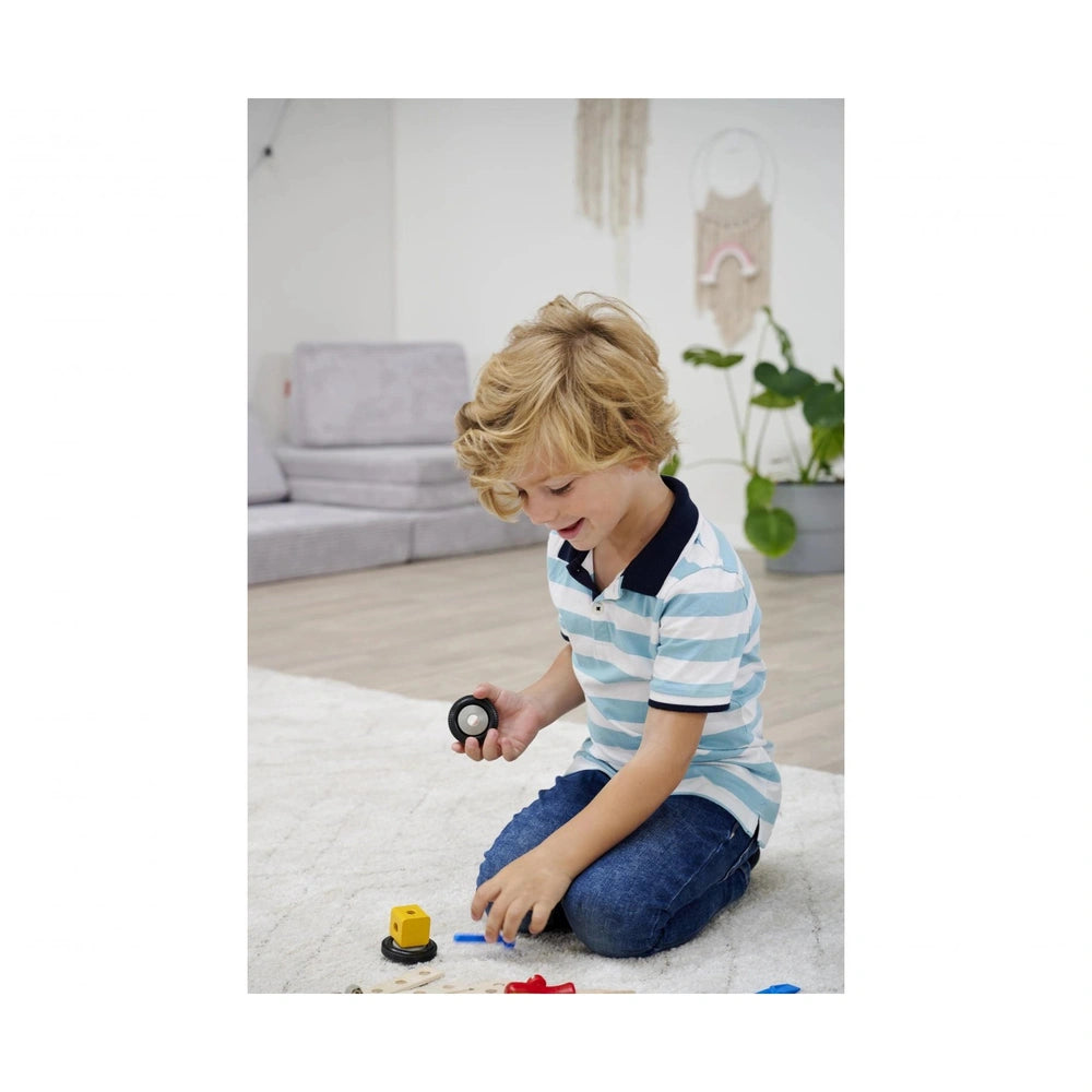 Eichhorn Constructor Expansion Set with 75 pieces is being explored by a young child on a light-colored carpet indoors.