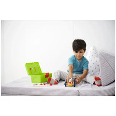 Eichhorn Constructor Racer Car toy held by a young boy in a blue t-shirt and white pants, featuring a bright red design.