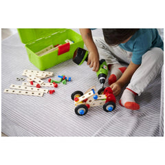 Eichhorn Constructor Racer Car set features a wooden car with plastic wheels on a white fabric surface with a green container