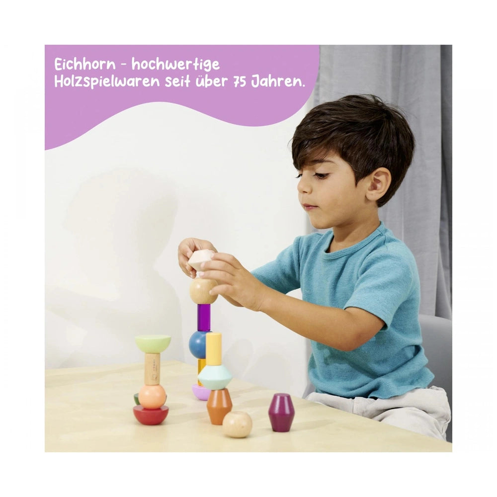 Eichhorn Montessori stacking beads in vibrant colors, with a child engaged in play at a simple indoor table setting.
