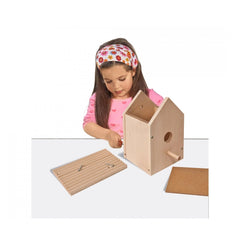 Eichhorn outdoor make your own birdhouse kit featuring a girl crafting with wood and tools in a bright, focused setting.
