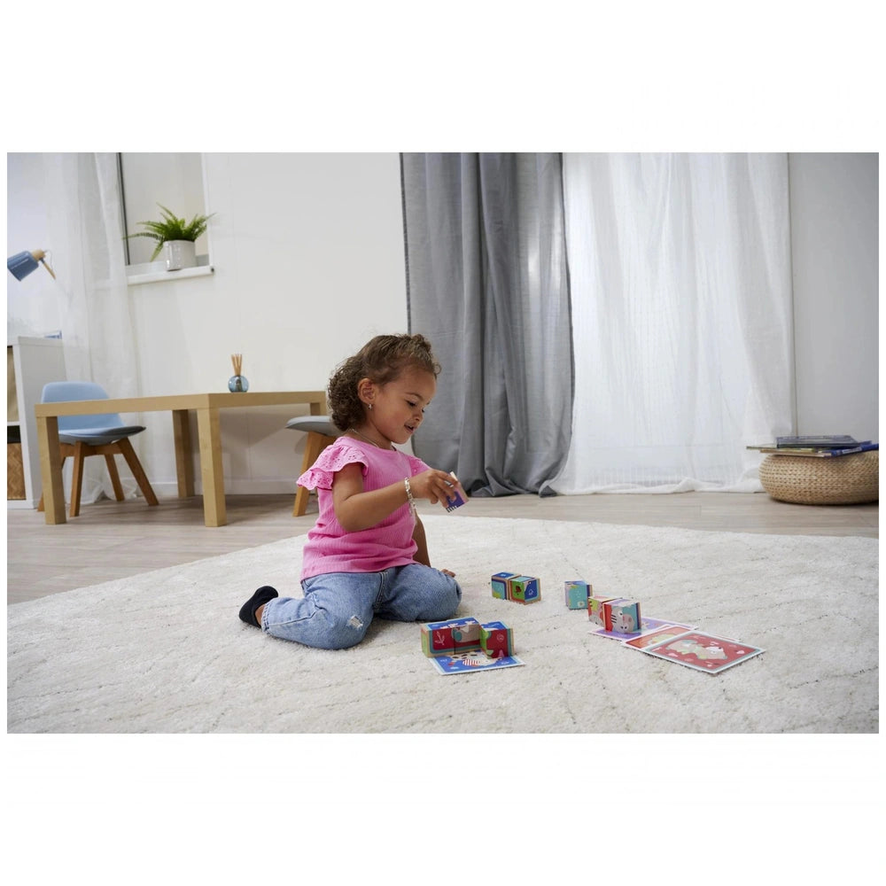 Eichhorn Picture Cube Friends set displayed with a child playing on a carpet, colorful blocks and a cozy living space in the 