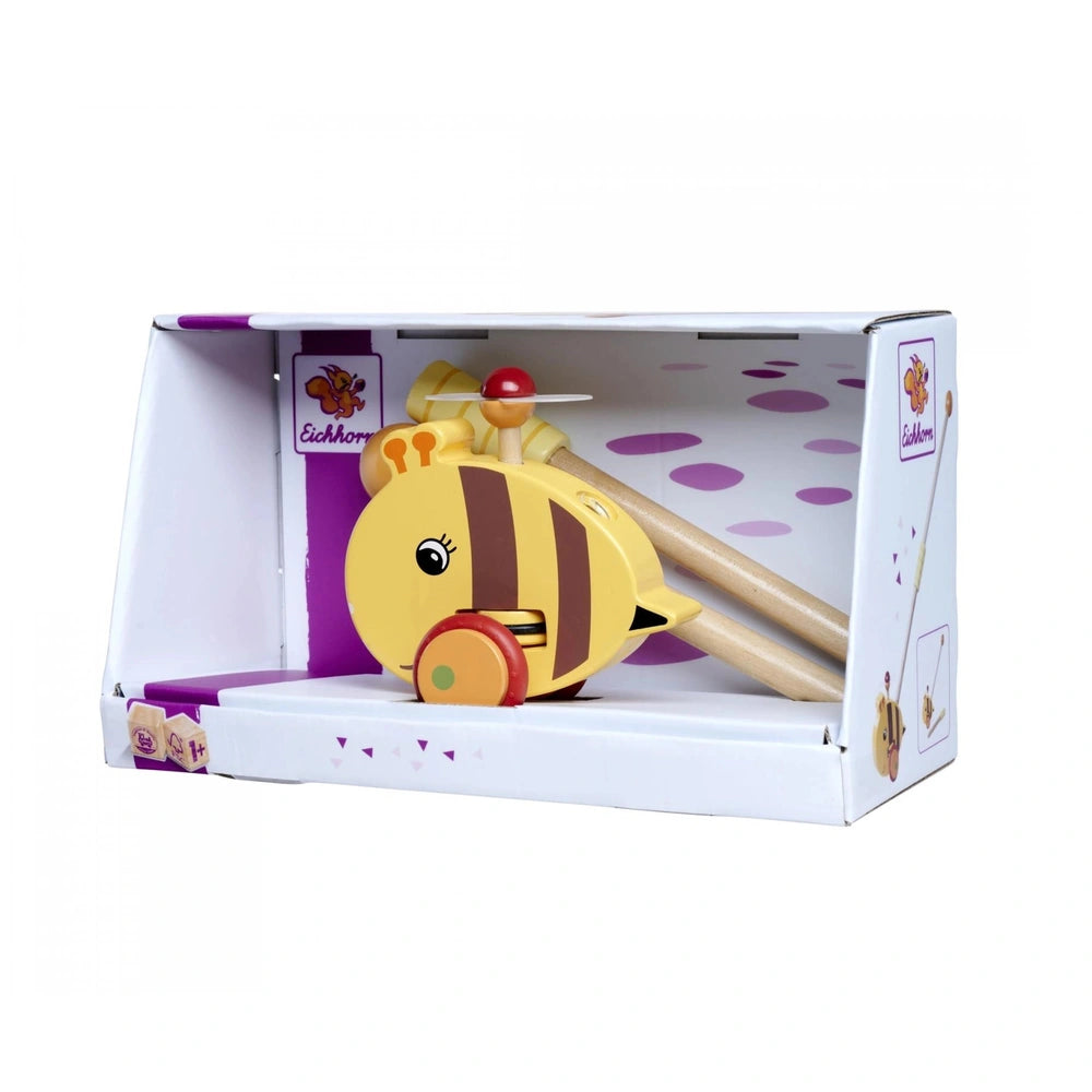 Eichhorn Push Bee toy set in packaging, featuring a bee with yellow stripes and a toy violin on a white background.