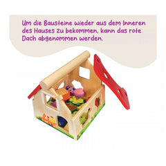 Eichhorn Sorting Farm baby activity toy features a wooden house with colorful toys inside and a removable red roof.